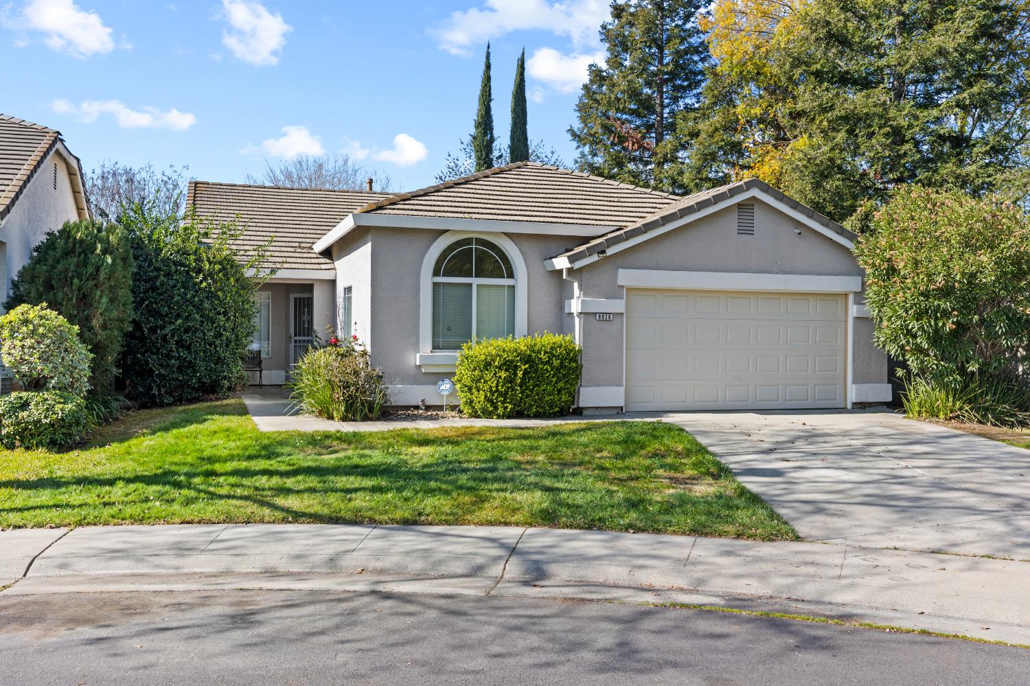 a front view of a house with a yard garage and outdoor seating