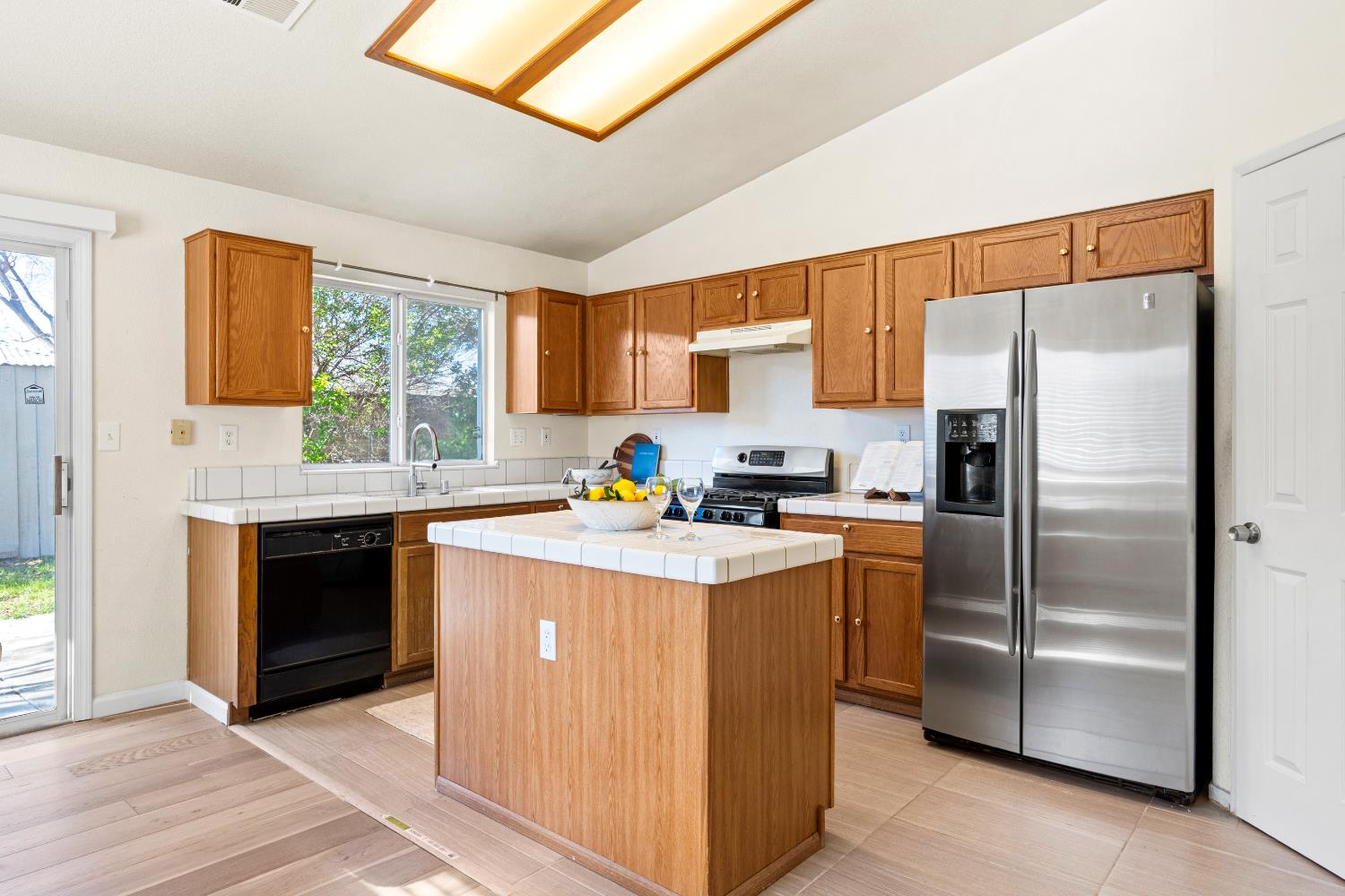 8926 Generations Court Elk Grove, CA 95758 - Photo 12 of 23 a kitchen with a refrigerator sink and cabinets