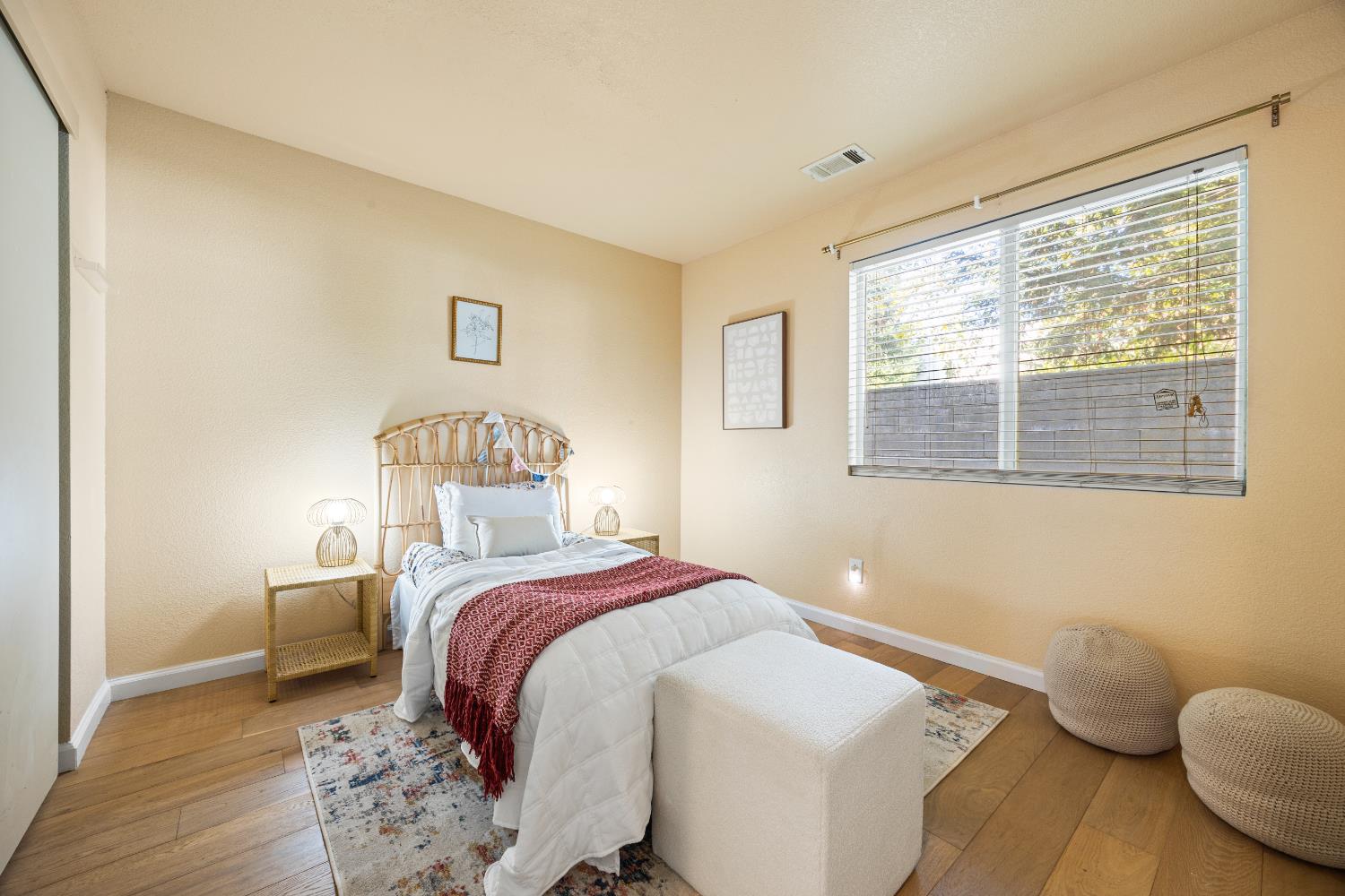 8926 Generations Court Elk Grove, CA 95758 - Photo 14 of 23 a bedroom with a bed and wooden floor