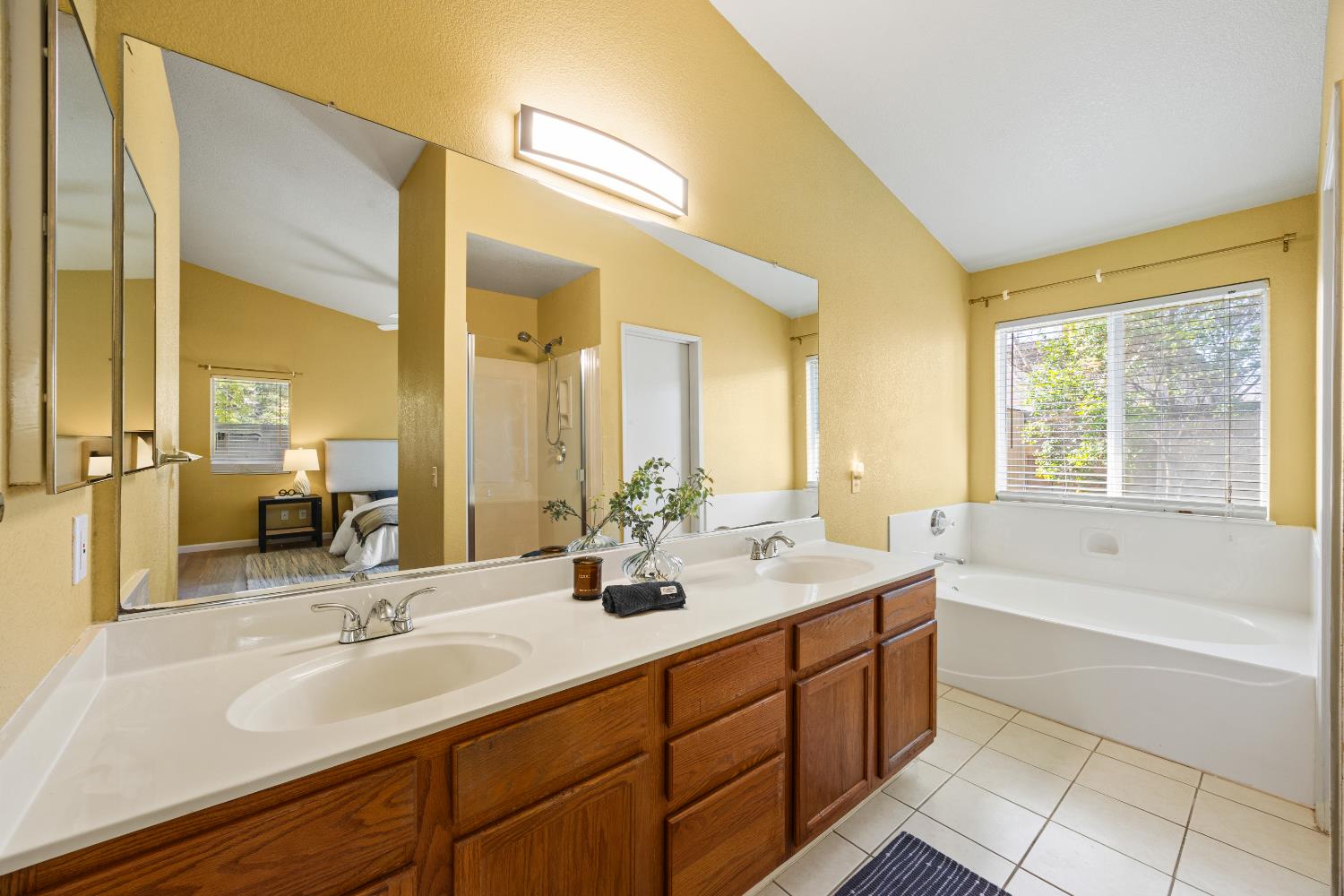8926 Generations Court Elk Grove, CA 95758 - Photo 18 of 23 a bathroom with a tub sink and mirror