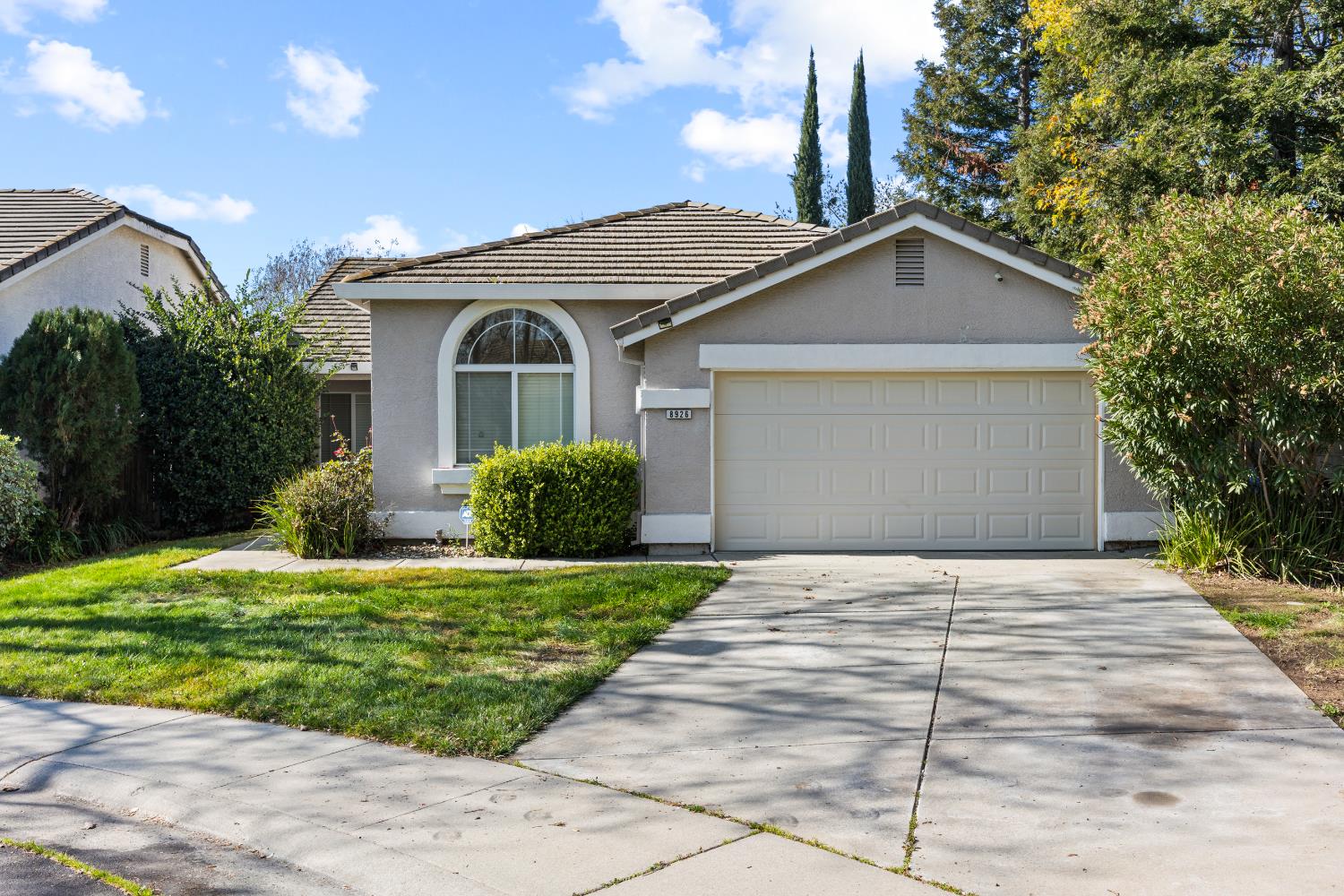 8926 Generations Court Elk Grove, CA 95758 - Photo 2 of 23 a front view of a house with a garden