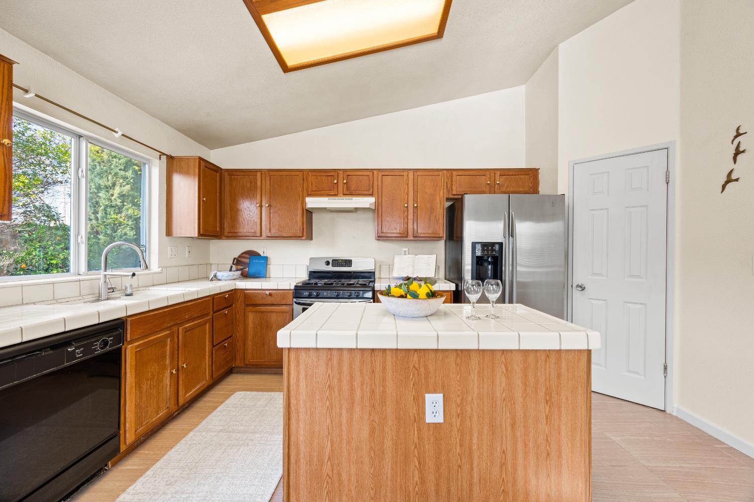 8926 Generations Court Elk Grove, CA 95758 - Photo 9 of 23 a kitchen with stainless steel appliances a sink stove and cabinets