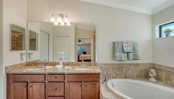 a bedroom with two beds and a chandelier