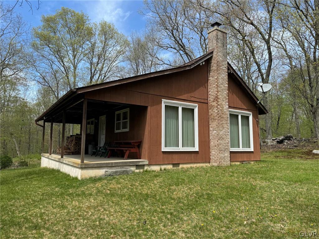 a view of house with yard