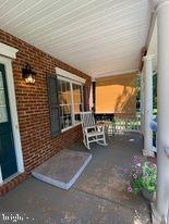7575 Moormont Road Rapidan, VA 22733 - Photo 11 of 59 a view of a patio with table and chairs and potted plants