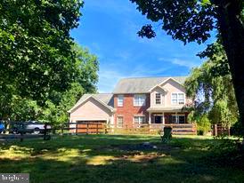7575 Moormont Road Rapidan, VA 22733 - Photo 2 of 59 a front view of a house with a garden