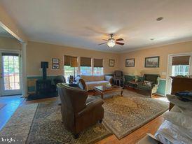 7575 Moormont Road Rapidan, VA 22733 - Photo 28 of 59 a living room with furniture and a wooden floor