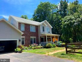 7575 Moormont Road Rapidan, VA 22733 - Photo 3 of 59 a front view of a house with a yard and potted plants
