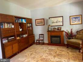 7575 Moormont Road Rapidan, VA 22733 - Photo 35 of 59 a living room with furniture a flat screen tv and a fireplace