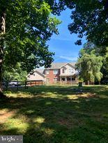 7575 Moormont Road Rapidan, VA 22733 - Photo 4 of 59 a front view of a house with a garden