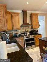 7575 Moormont Road Rapidan, VA 22733 - Photo 41 of 59 a kitchen with stainless steel appliances granite countertop a stove a sink and a microwave
