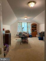 7575 Moormont Road Rapidan, VA 22733 - Photo 53 of 59 a living room with furniture a dining table and a fireplace