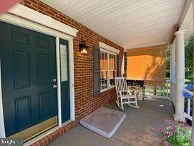 7575 Moormont Road Rapidan, VA 22733 - Photo 10 of 59 a view of a porch with chairs and floor to ceiling window