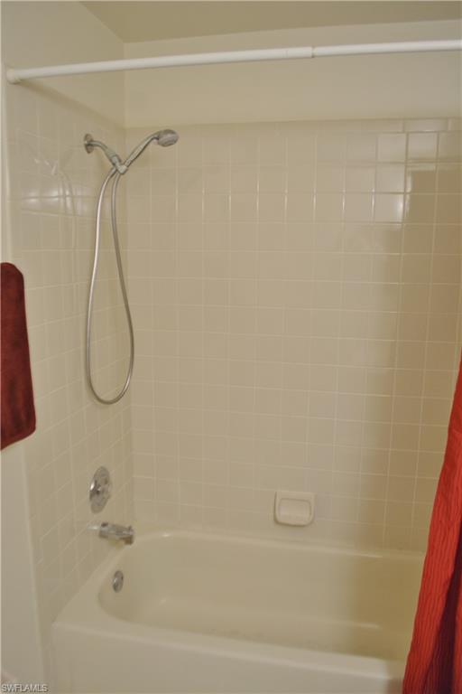 240 Timber Lake Circle, Unit D202 Naples, FL 34104 - Photo 11 of 23 a bathroom with a bath tub and a shower