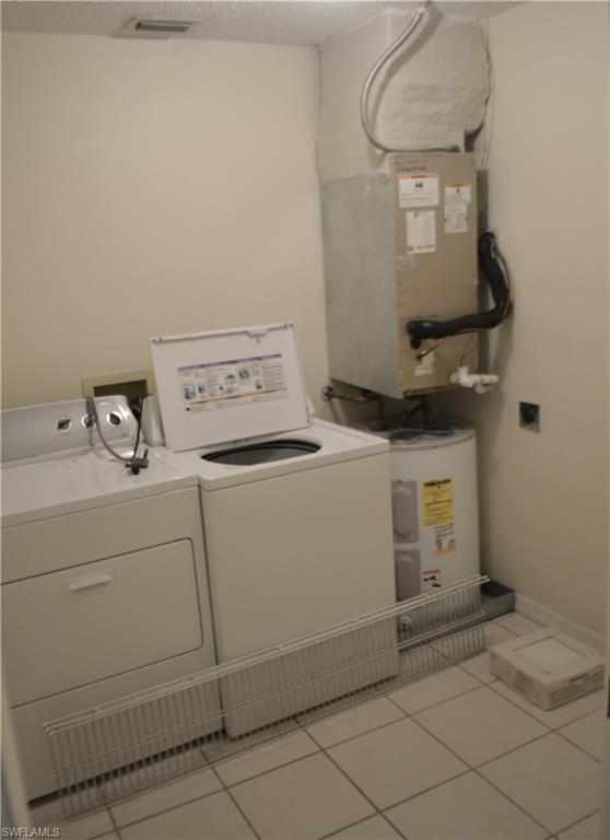 240 Timber Lake Circle, Unit D202 Naples, FL 34104 - Photo 12 of 23 a utility room with dryer and washer