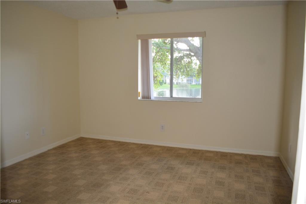 240 Timber Lake Circle, Unit D202 Naples, FL 34104 - Photo 13 of 23 an empty room with a window