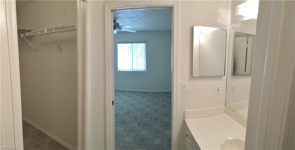 240 Timber Lake Circle, Unit D202 Naples, FL 34104 - Photo 16 of 23 a bathroom with a glass shower door