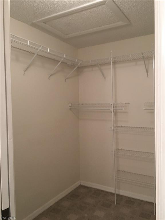 240 Timber Lake Circle, Unit D202 Naples, FL 34104 - Photo 17 of 23 a view of an empty walk in closet