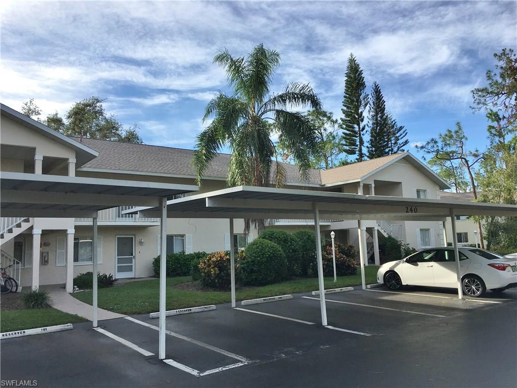 240 Timber Lake Circle, Unit D202 Naples, FL 34104 - Photo 2 of 23 a view of a car park in front of house