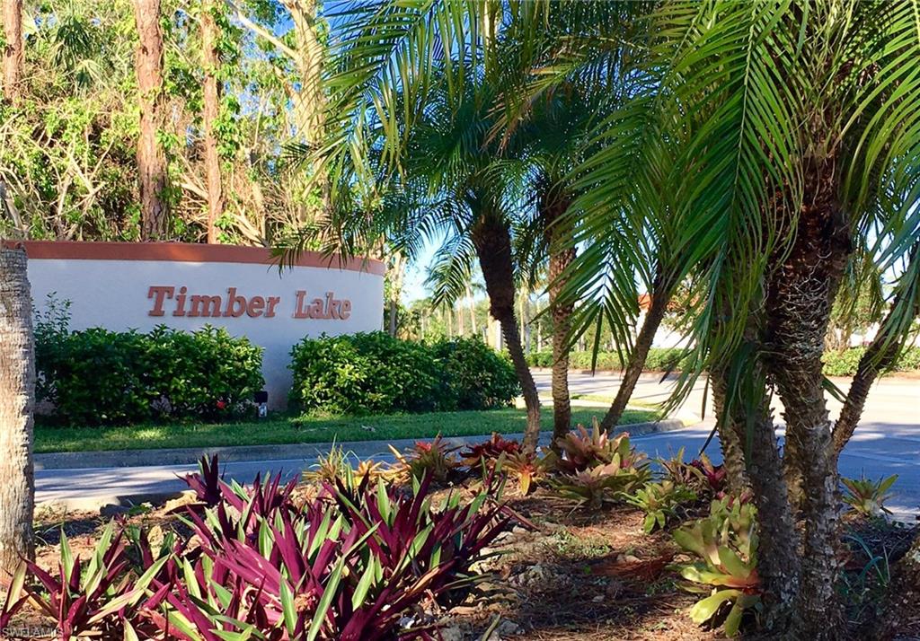 240 Timber Lake Circle, Unit D202 Naples, FL 34104 - Photo 23 of 23 a view of a bench in a garden