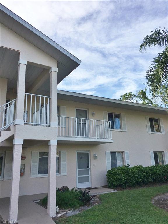 240 Timber Lake Circle, Unit D202 Naples, FL 34104 - Photo 3 of 23 a front view of a house with garden