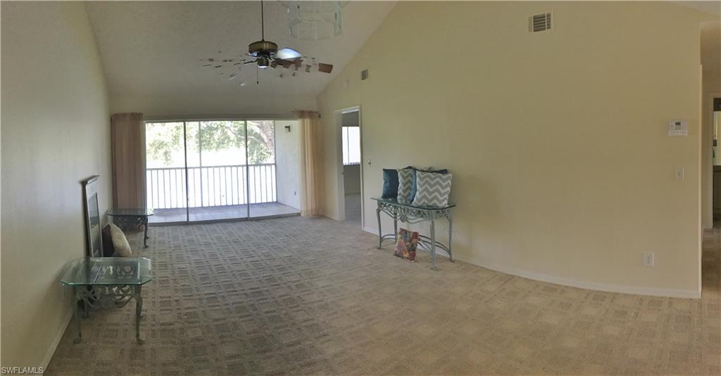 240 Timber Lake Circle, Unit D202 Naples, FL 34104 - Photo 5 of 23 wooden floor in an empty room with a window