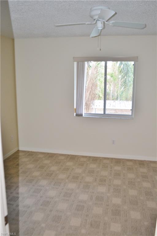 240 Timber Lake Circle, Unit D202 Naples, FL 34104 - Photo 8 of 23 an empty room with a window