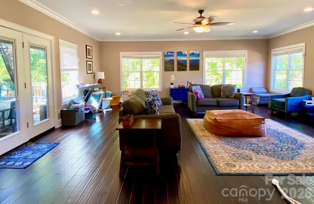 a living room with furniture and painting on the wall