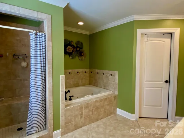 a bedroom with a bed a couch and a dresser in it