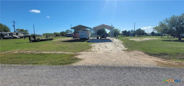 a view of a house with backyard and sitting area