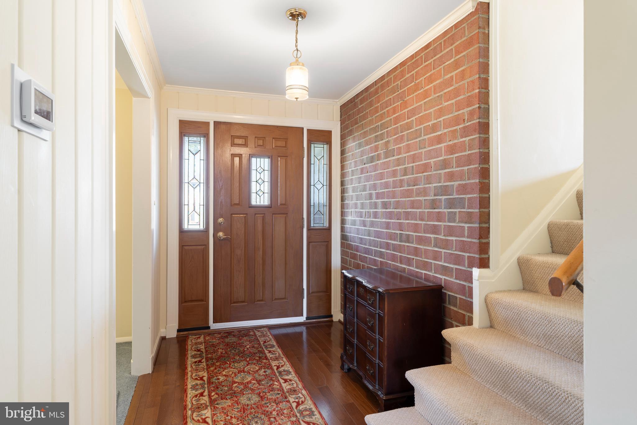 119 East Padonia Road Lutherville-Timonium, MD 21093 - Photo 6 of 39 a hallway with furniture and a fireplace