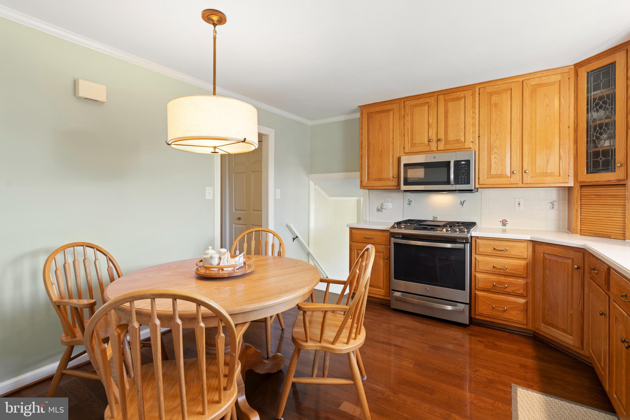 119 East Padonia Road Lutherville-Timonium, MD 21093 - Photo 9 of 39 a kitchen with stainless steel appliances a stove a sink a dining table and chairs
