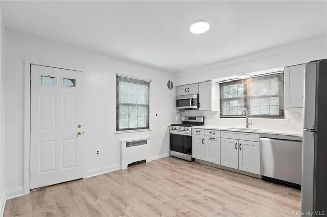 a large kitchen with stainless steel appliances granite countertop a stove and a sink