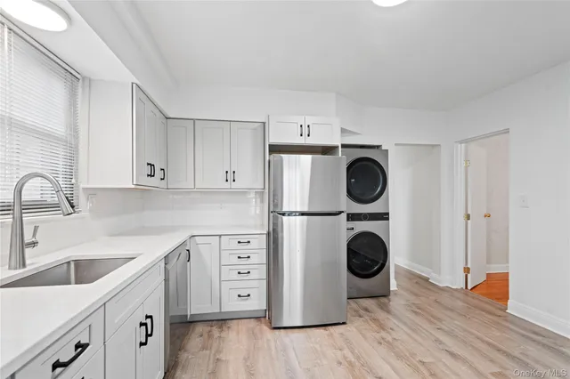 a view of a kitchen with sink washer and dryer