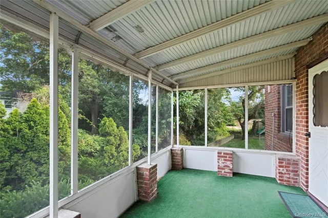 a view of a porch with chairs and backyard