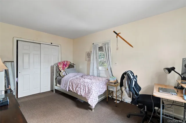 a bedroom with a bed and a desk