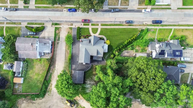 an aerial view of a house with a yard basket ball court and outdoor seating