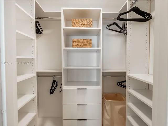 a view of walk in closet with empty racks