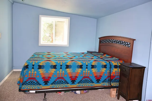 a room with chairs and a painting on the wall