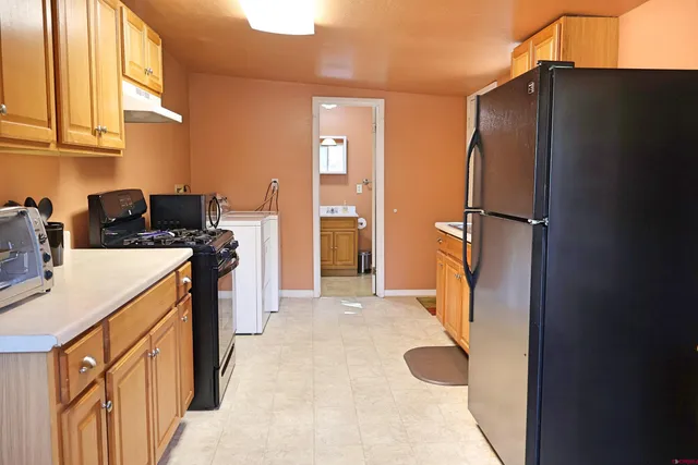 a kitchen with a refrigerator and a stove