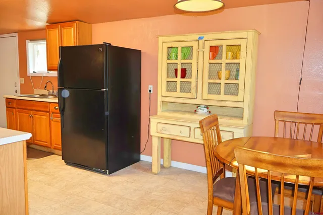 a kitchen with stainless steel appliances a refrigerator and a stove top oven