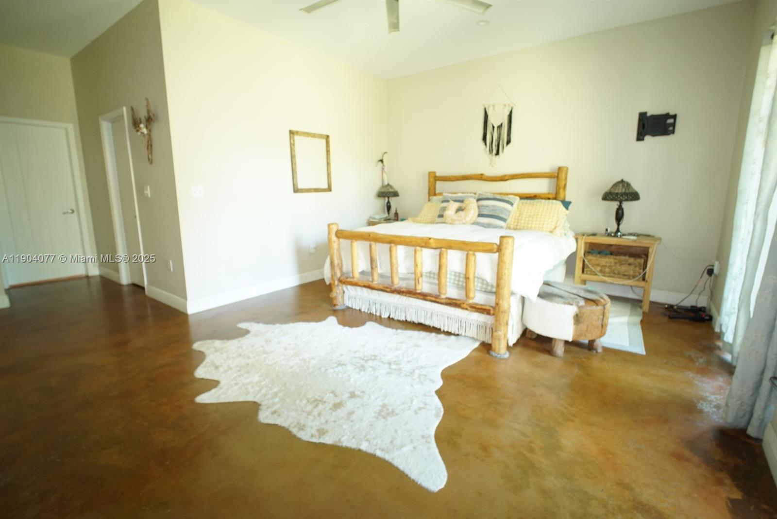 2184 9 Mile Road LaBelle, FL 33935 - Photo 11 of 41 a spacious bedroom with a bed and wooden floor