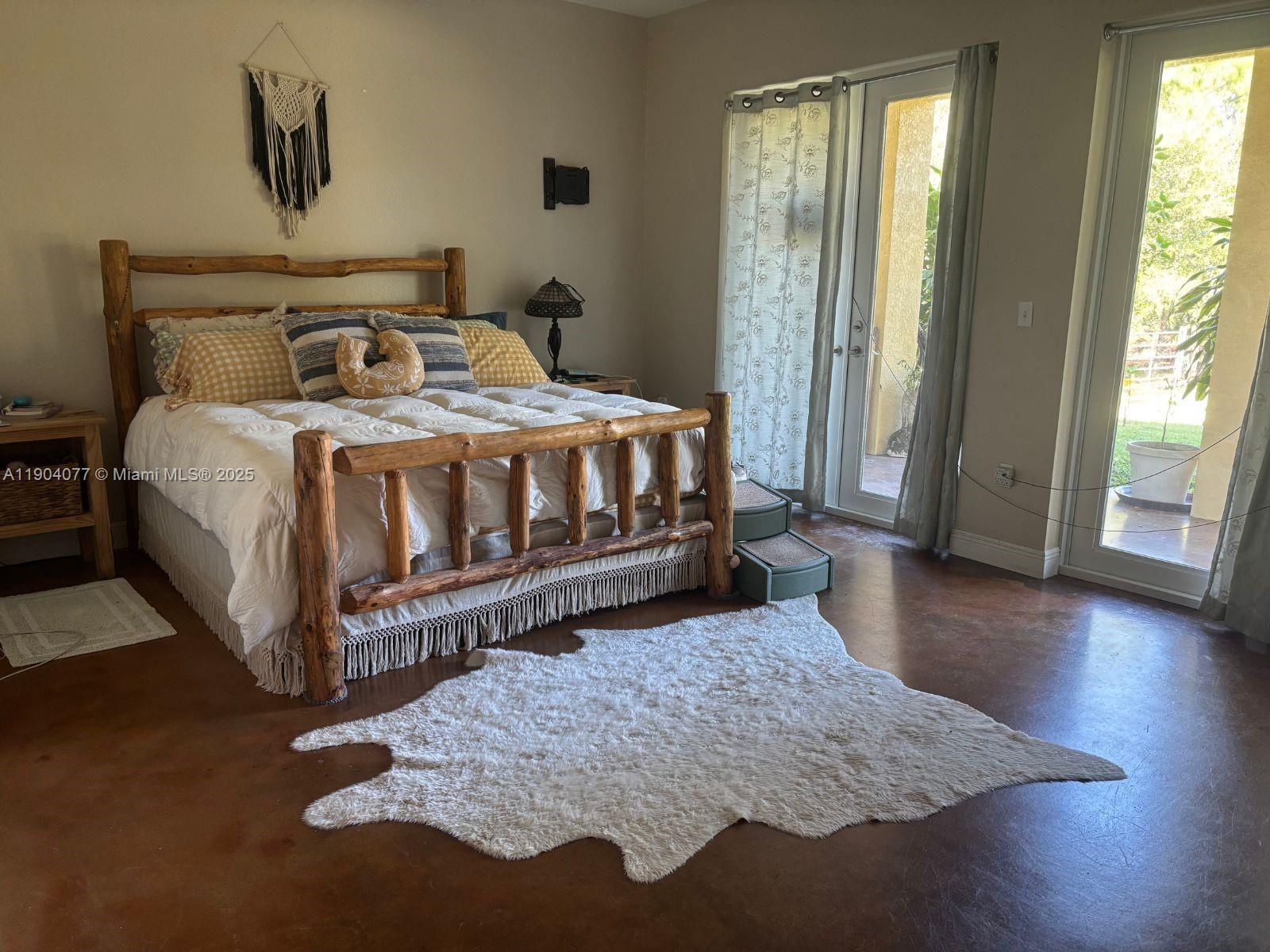 2184 9 Mile Road LaBelle, FL 33935 - Photo 12 of 41 a bedroom with a bed and wooden floor