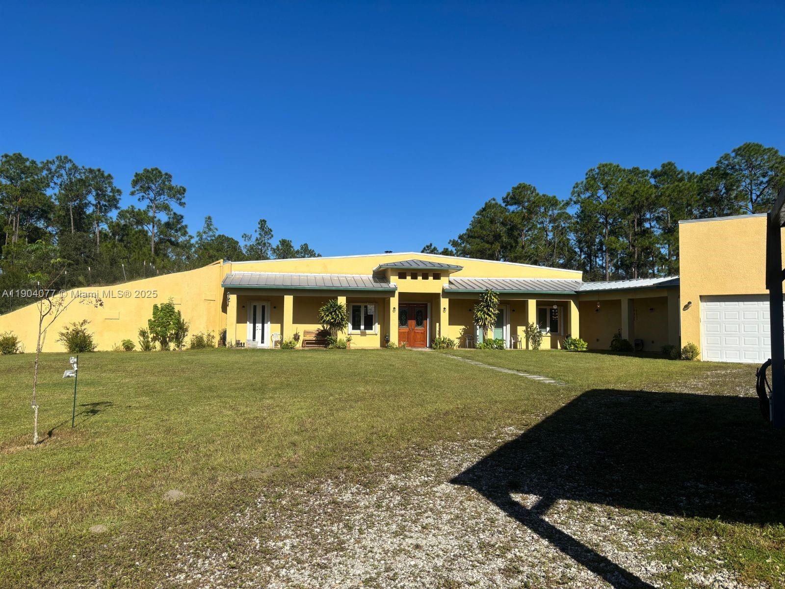 2184 9 Mile Road LaBelle, FL 33935 - Photo 2 of 41 a front view of a house with a yard