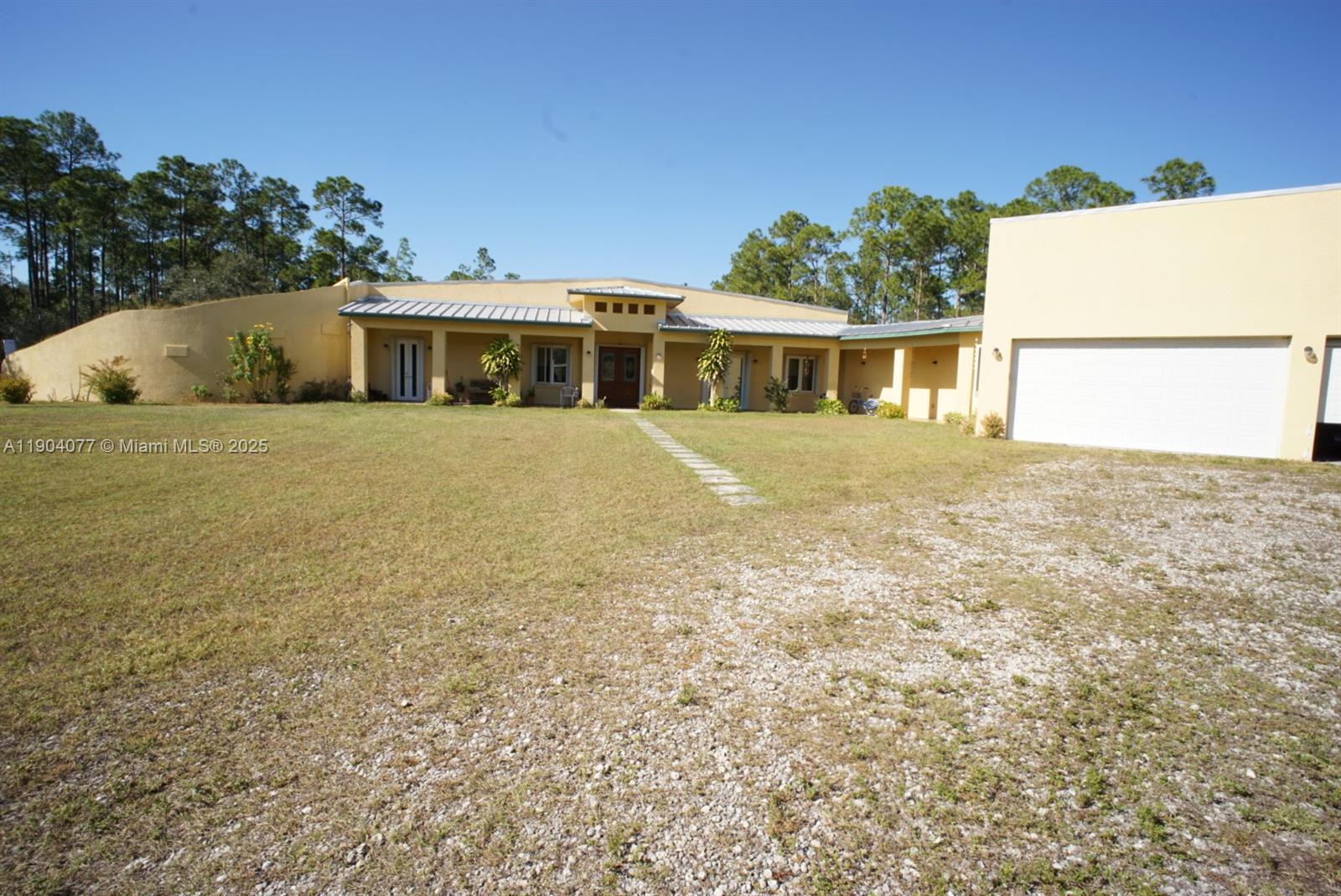 2184 9 Mile Road LaBelle, FL 33935 - Photo 3 of 41 a front view of a house with a garden