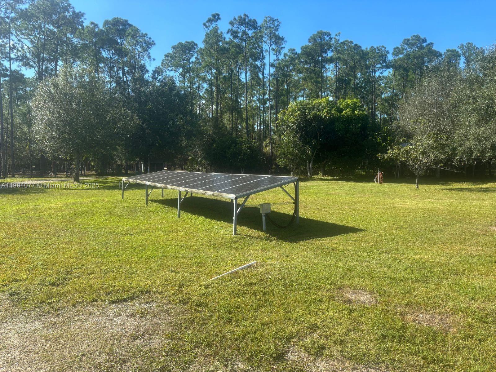 2184 9 Mile Road LaBelle, FL 33935 - Photo 31 of 41 a view of a swimming pool with an outdoor space and seating area