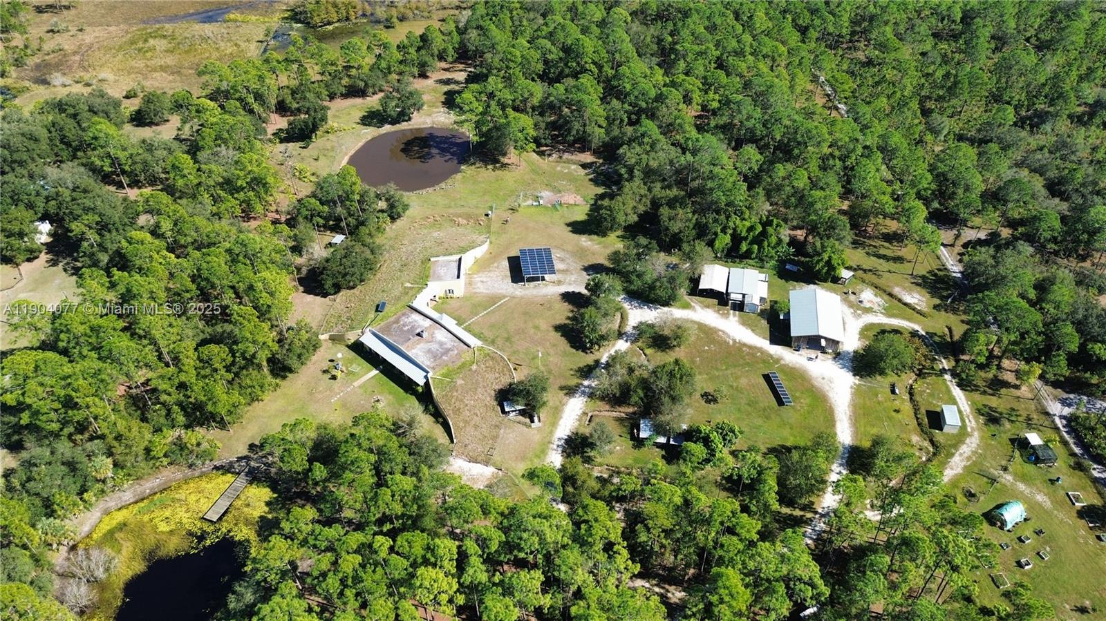 2184 9 Mile Road LaBelle, FL 33935 - Photo 4 of 41 an aerial view of residential house with outdoor space and trees all around