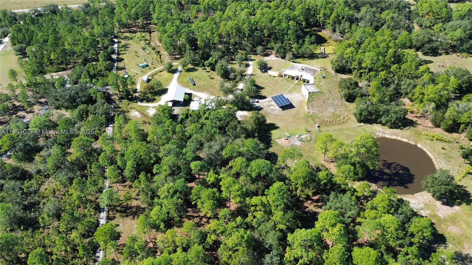 2184 9 Mile Road LaBelle, FL 33935 - Photo 5 of 41 an aerial view of residential house with outdoor space and trees all around
