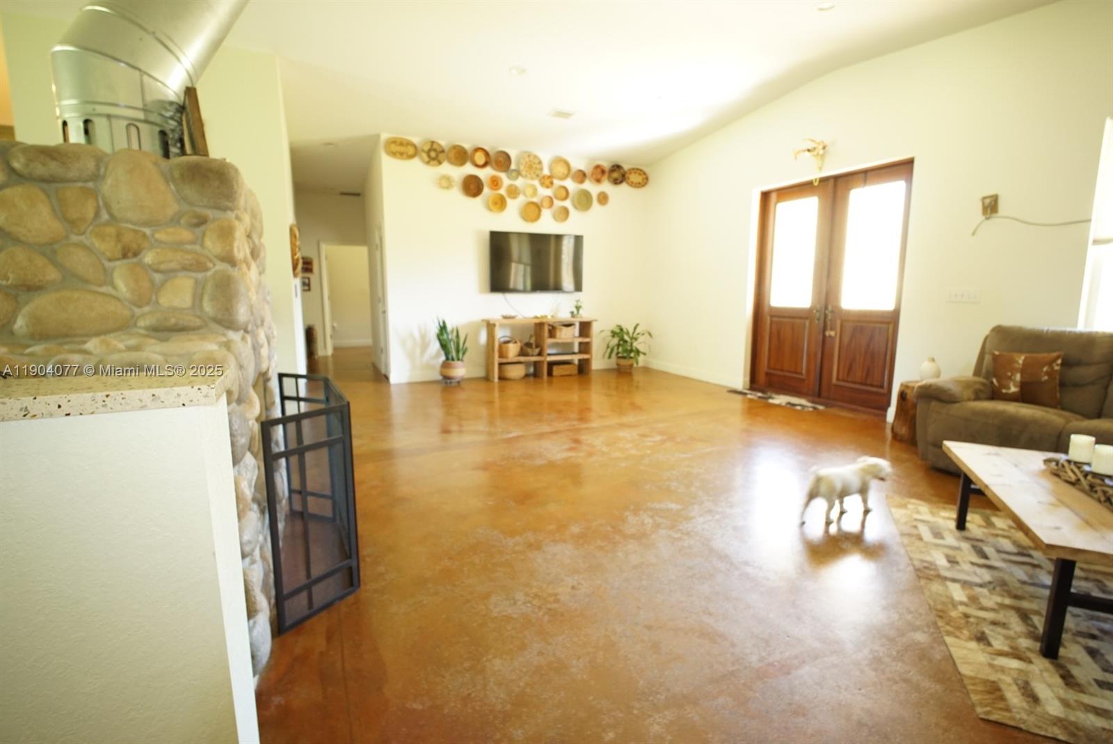 2184 9 Mile Road LaBelle, FL 33935 - Photo 7 of 41 a living room with fireplace furniture and a flat screen tv