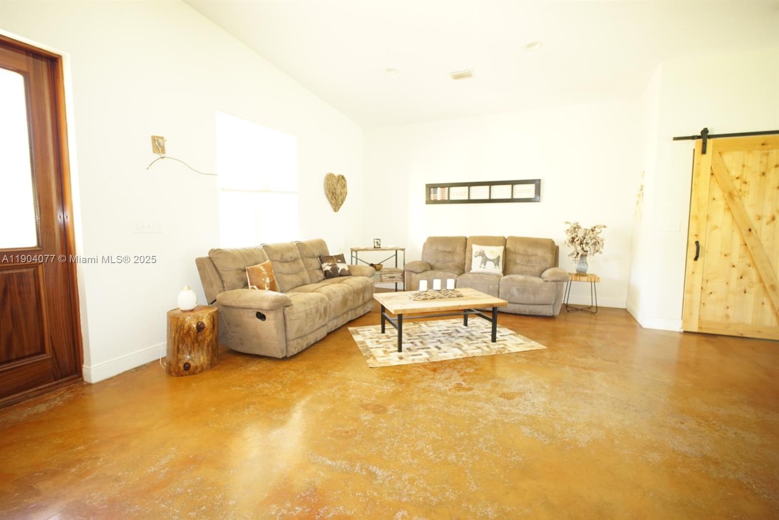 2184 9 Mile Road LaBelle, FL 33935 - Photo 8 of 41 a living room with furniture and a large window